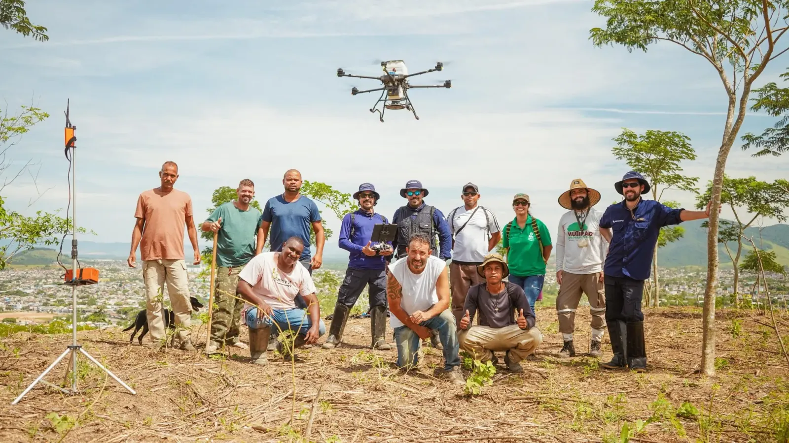 The planting crew and the seeding drone on a Rio de Janeiro hillside above the city