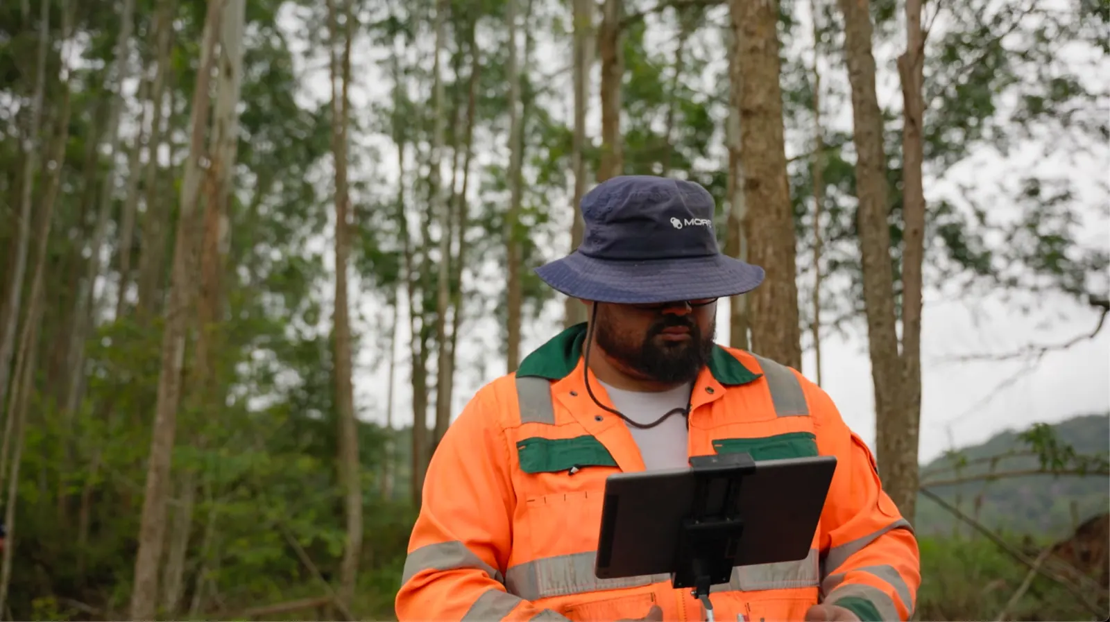 A field agent running a monitoring pass from a tablet on the site
